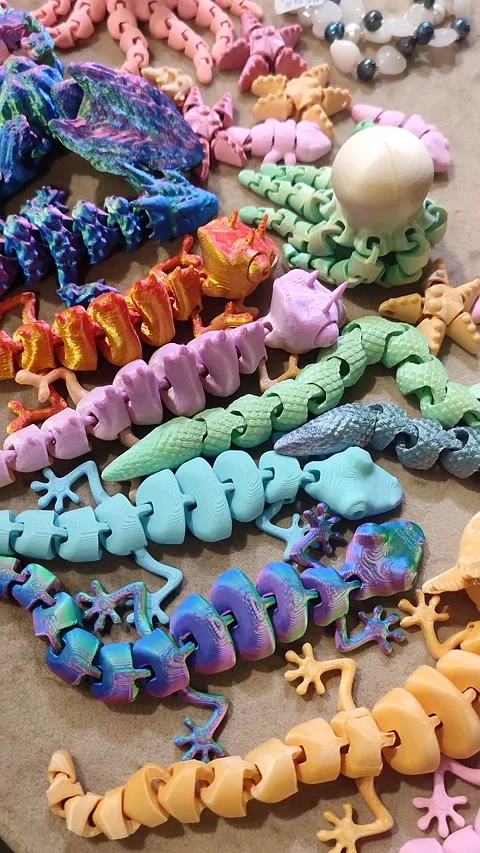 Creative multi-colored models printed on 3D printer from molten plastic Vertical Stock Footage 303359712