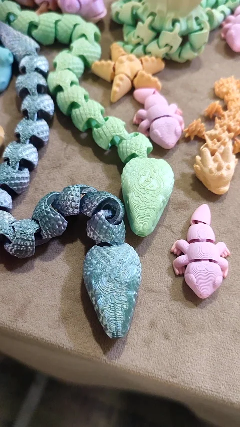 Creative multi-colored models printed on 3D printer from molten plastic Vertical Stock Footage 303837713