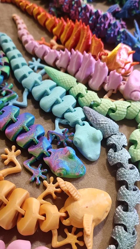 Creative multi-colored models printed on 3D printer from molten plastic Vertical Stock Footage 303837775