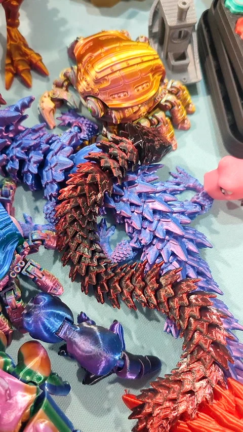 Creative multi-colored models printed on 3D printer from molten plastic Vertical Stock Footage 303837922