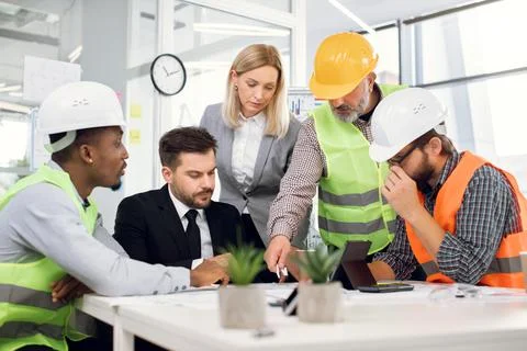 Creative multi ethnic team planning construction project Фото