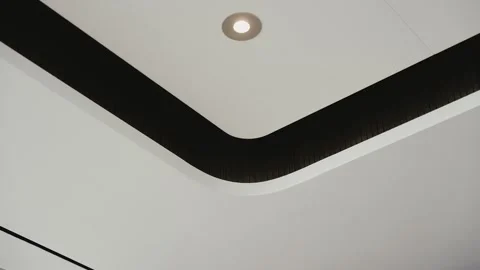 Creative multi-level stretch ceiling in black and white tones with round lights Stock Footage 263674553