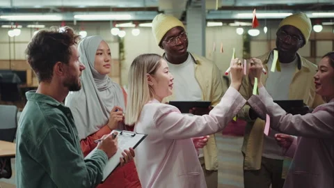Creative multiethnic business team making notes on sticky notes near the Stock Footage 209183612