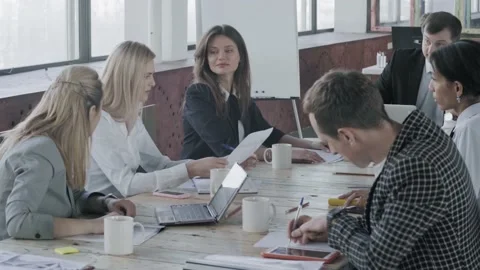 Creative multinational business team of professionals working on a project in Stock Footage 134158542