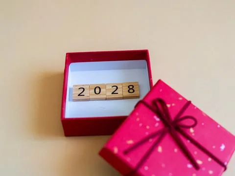 Creative new year celebration concept with 2028 wooden blocks in gift box o.. Stock Photos