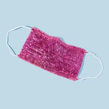 Creative New Years concept with protective face mask with sequins Stock Photos