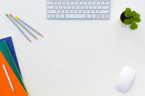 Creative Office Bright Table with Color Magazines and Pencils Computer and Foto stock