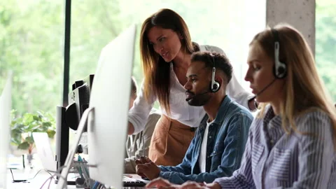 In Creative Office Coworkers Sitting at the Table, talking strategy with laptop Stock Footage 203974112
