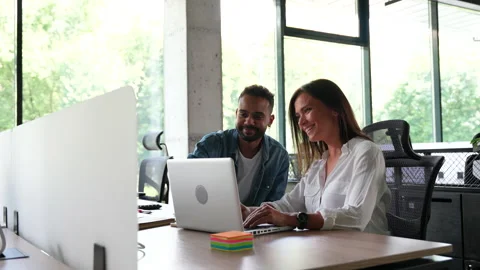 In Creative Office Coworkers Sitting at the Table, talking strategy with laptop Stock Footage 203974626
