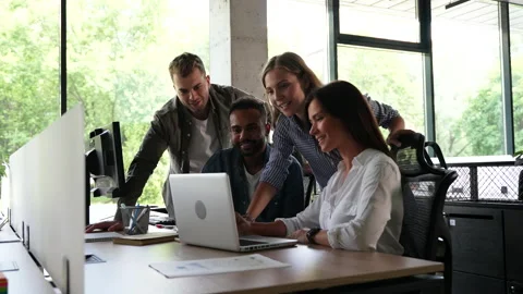 In Creative Office Coworkers Sitting at the Table, talking strategy with laptop Stock Footage 203974929