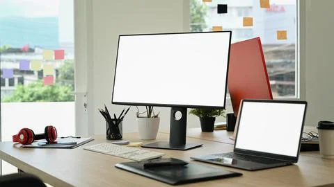 Creative office studio interior with laptop, blank screen computer, graphic 스톡 사진