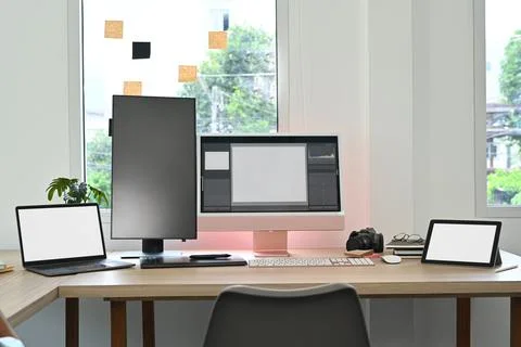 Creative office studio interior with laptop, blank screen computer, digital 스톡 사진