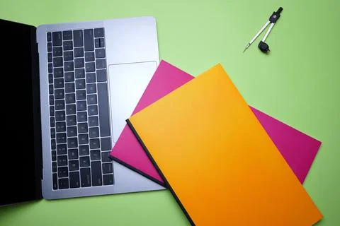 Creative Office table top, flat lay. Laptop, compass and colorful notebook on Stock Photos