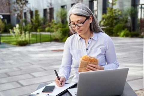 Creative office worker multitasking outdoors in open air Stock Photos