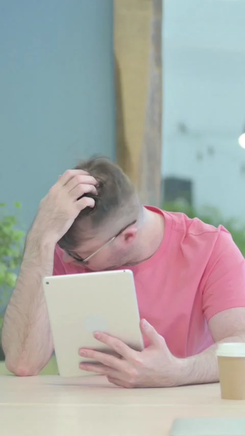 Creative Old Man Shocked by Loss on Digital Tablet, vertical video Stock Footage 329106385