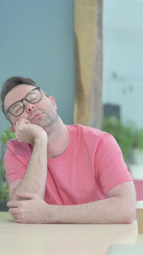 Creative Old Man Sleeping while Sitting at Work, vertical video Video stock 329106386