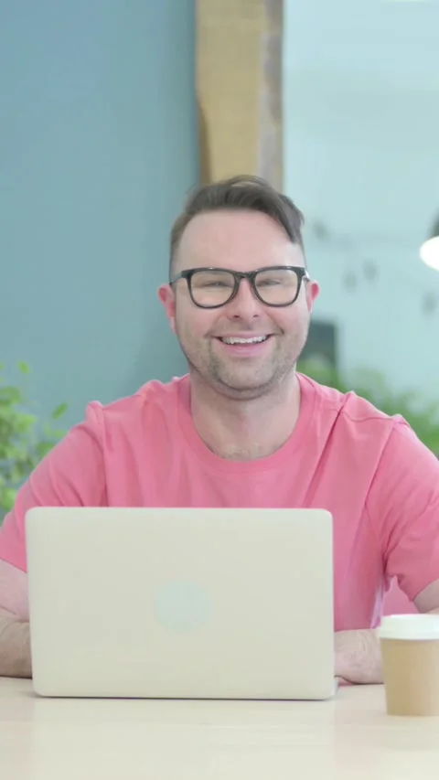 Creative Old Man Smiling at Camera while using Laptop, vertical video Stock-Footage 329106266