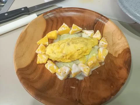 Creative Omelet Dish with Mango and Creamy White Sauce Stock Photos
