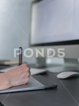 Creative or graphic designer using digital tablet and computer in the office Stock Photos