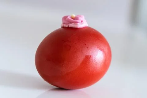 Creative painted red Easter egg on white. Background. Stock Photos