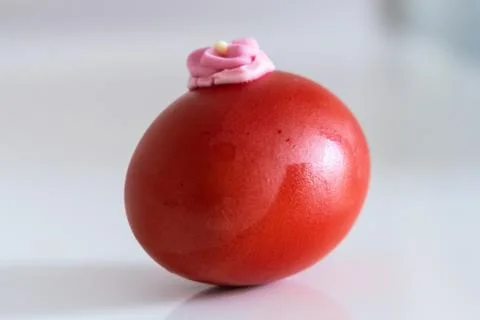 Creative painted red Easter egg on white Foto stock