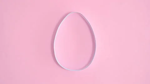Creative paper egg shape appear on pastel pink background. Flat lay stop motion 스톡 동영상 171674414