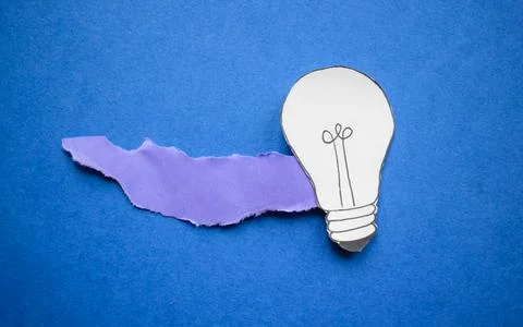 Creative paper light bulb idea concept on blue background Stock Photos