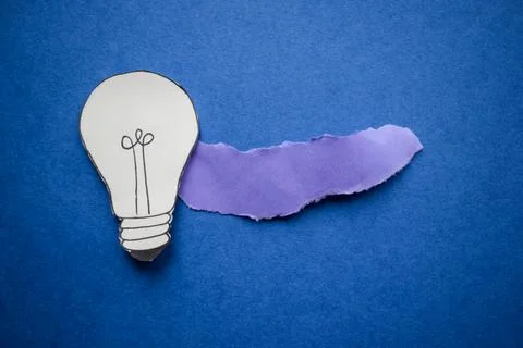 Creative paper light bulb idea concept on blue background Stock Photos