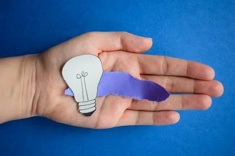 Creative paper light bulb idea concept on blue background Stock Photos