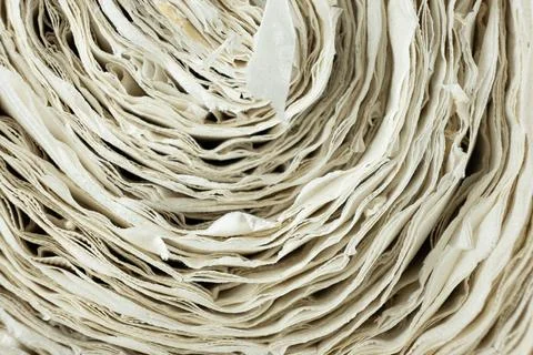 Creative paper roll swirl pattern close up. Фото