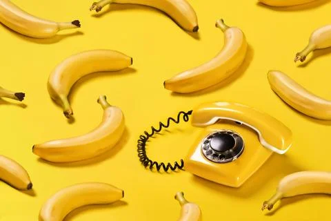Creative pattern bananas and old yellow phone with hard shadows pattern on Stock Illustration