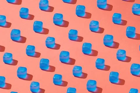 Creative pattern with blue light ice cubes with shadows on a background in .. Stock Photos