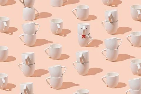 Creative pattern of cups on pastel pink background. Minimalist concept. Stock Photos