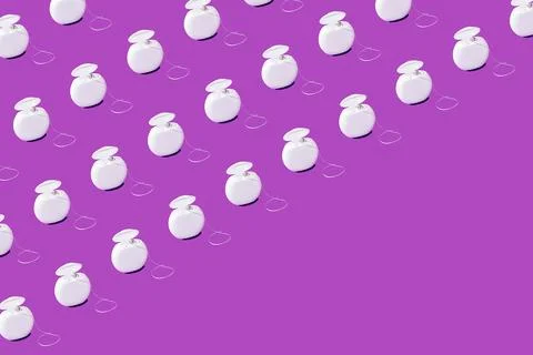 Creative pattern dental floss on purple background flat lay top view copy spa Stock Photos