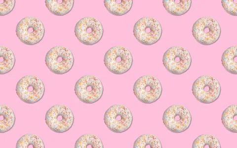 Creative pattern design of glazed donuts on pink background Stock Photos