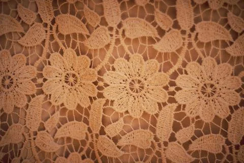 Creative pattern design made of handmade crochet on brown background. Stock Photos