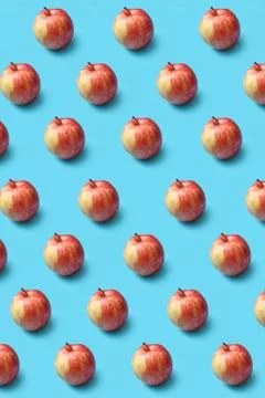 Creative pattern from fresh organic red apples on a blue background. Stock-Fotos