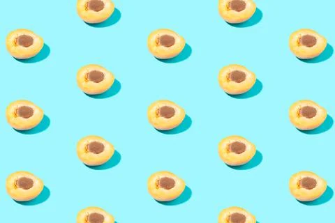 Creative pattern of halves of apricots on a green background Fotos Stock