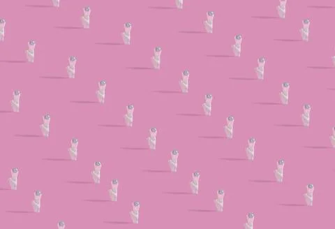 A creative pattern with human hands holding shiny disco ball on pastel pink b Stock Photos