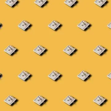 Creative pattern made 100 dollar bills on yellow background. Minimal financia 스톡 사진