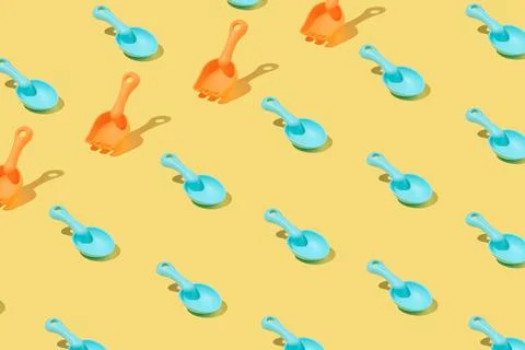 Creative pattern made of blue and orange plastic beach toy shovels isolated on 스톡 사진