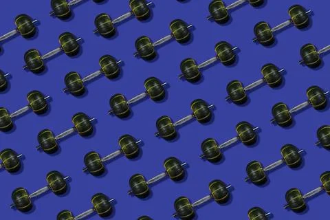 Creative pattern made of dumbbells with a weight in the form of pumpkins, cyan Stock Photos