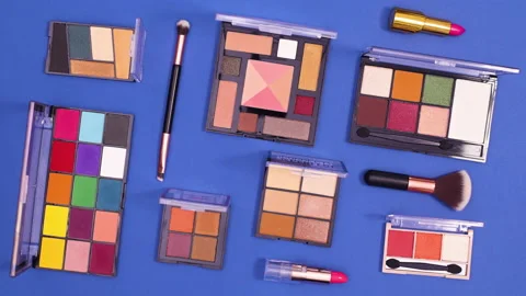 Creative pattern made of make up move on dark blue background. Stop motion Stock Footage 153174823