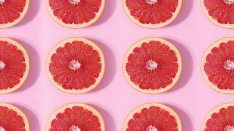 Creative pattern made of sliced grapefruits rotating. Stop motion flat lay Stock Footage 153177550