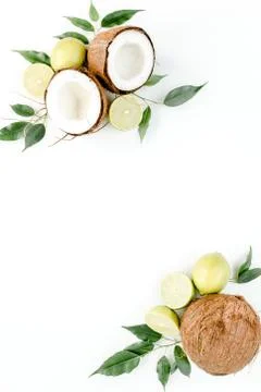 Creative pattern made of summer tropical fruits: coconut, lime and leaves ficus Foto stock