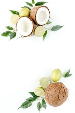 Creative pattern made of summer tropical fruits: coconut, lime and leaves ficus Foto stock