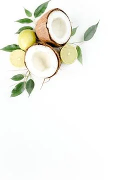 Creative pattern made of summer tropical fruits: coconut, lime and leaves ficus Stock Photos