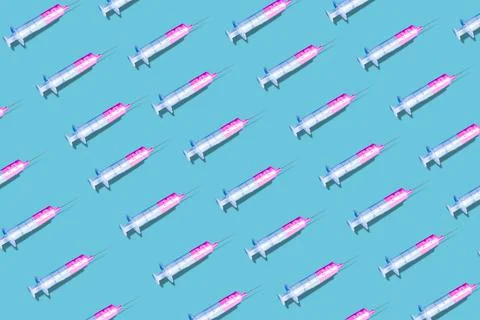 Creative pattern made with a syringe on blue background Stock Photos