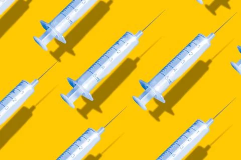 Creative pattern made with a syringe on blue background Foto stock