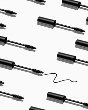 Creative pattern of mascara brushes on white background. Make up products. Stock Photos